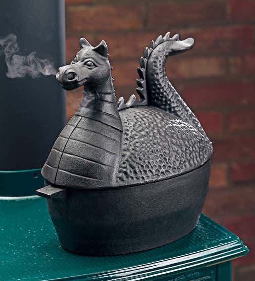 A Cast Iron Dragon Wood Stove Steamer with steam coming out of his nose