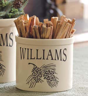 A ceramic storage crock with a personalized name and a pinecone motif. Shop Personalized Gifts