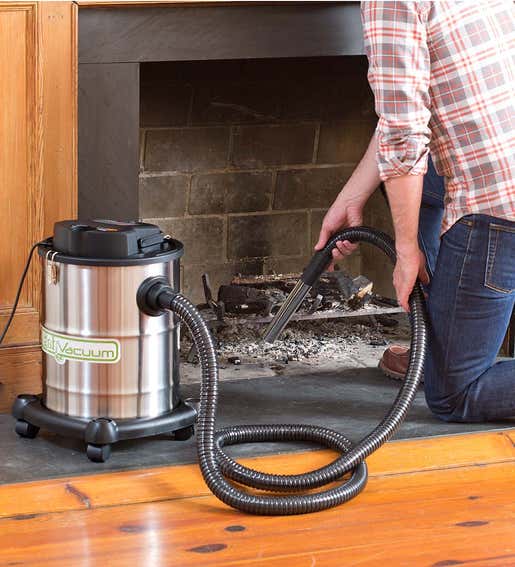 A man cleans a fireplace with Heavy-Duty Fireplace Warm Ash Vacuum