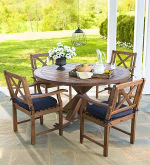 Claremont eucalyptus wood dining set with blue cushions on a back porch.