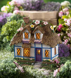 Image of a miniature stone fairy cottage with solar lights. Shop Gnomes & Fairy Gardens