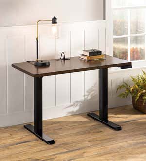 An adjustable height home office standing desk with built-in charging station.