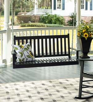 A black slatted wood porch swing on a front porch.