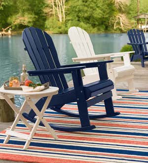 ROCKING CHAIRS & GLIDERS > Image of brightly painted wood Adirondack rocking chairs on a dock