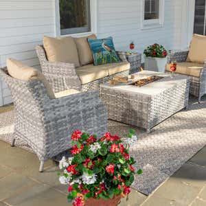 St. Helena wicker seating set with fire pit table beside a lake.