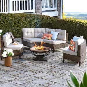 OUTDOOR SOFAS & SECTIONALS > Evening shot of a Kingwood modular half-round deep wicker seating set with coffee table.