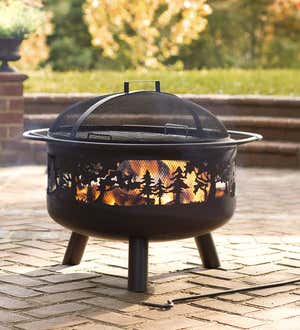 FIRE PITS > An image of a blazing Timberline fire pit on a brick patio.